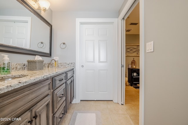 9450 S Thomas Dr Unit 402, Panama City, FL 32408 - bathroom featuring double vanity and tile patterned floors