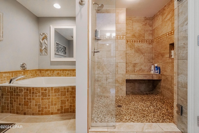 full bathroom with tile patterned floors, a shower stall, and a bath