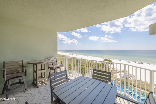 balcony with a view of the beach and a water view