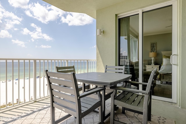 balcony featuring a water view and a view of the beach