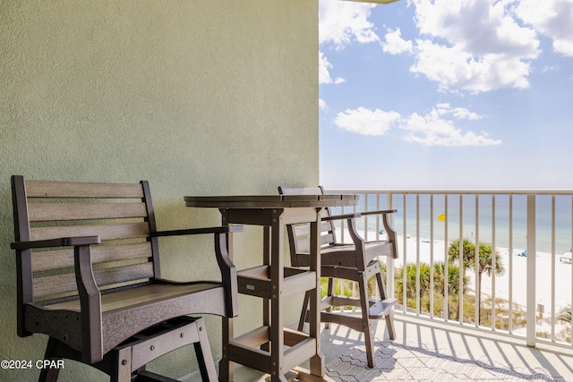 balcony featuring a water view and a view of the beach