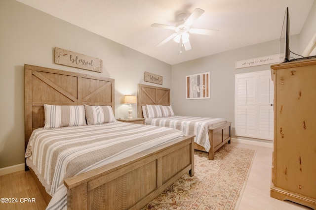 bedroom featuring light hardwood / wood-style floors and ceiling fan