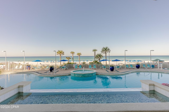 9450 S Thomas Dr Unit 402, Panama City, FL 32408 - community pool with a hot tub, a water view, and a patio