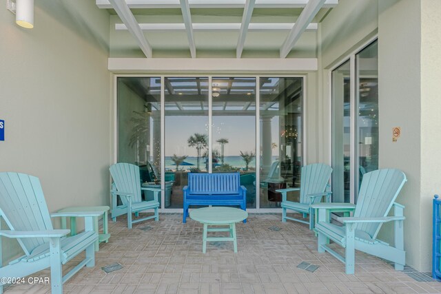 view of pool with a patio, a water view, and a community hot tub