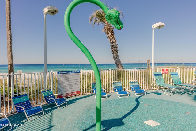 view of patio / terrace with a community pool, a pergola, and a water view