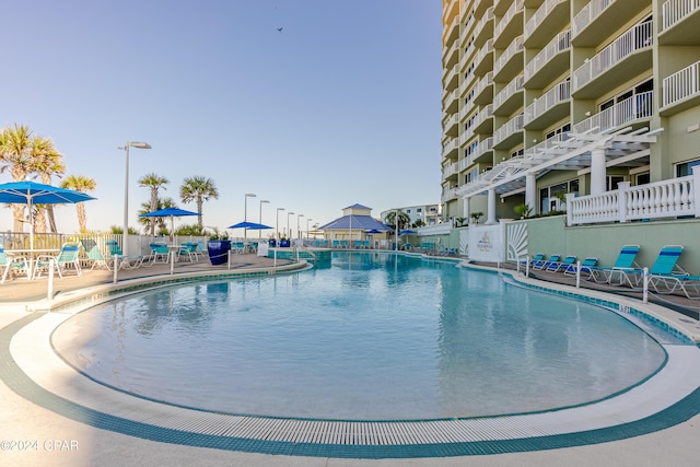 community pool featuring a patio area and fence