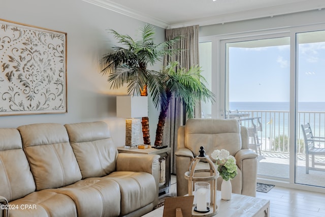 living room with hardwood / wood-style floors, ornamental molding, and a water view