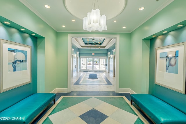 corridor featuring a chandelier, recessed lighting, baseboards, a tray ceiling, and crown molding