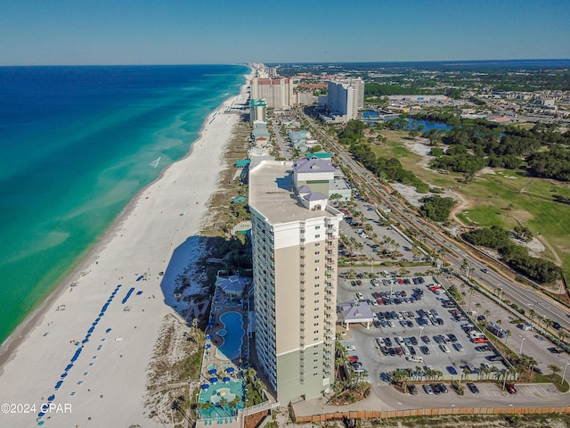 bird's eye view featuring a view of the beach, a water view, and a city view