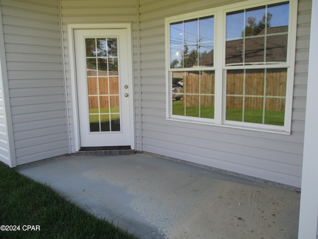 entrance to property featuring a patio area