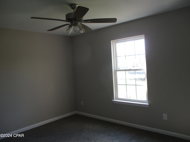 carpeted spare room with ceiling fan