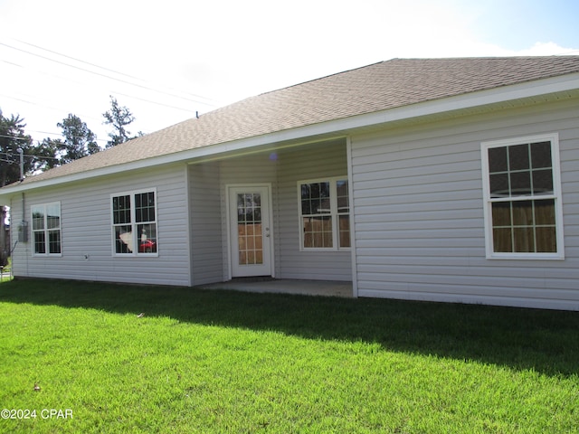 rear view of property with a lawn