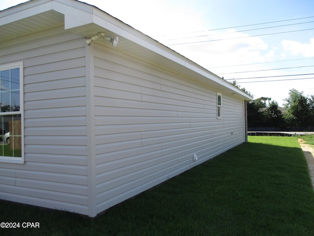 view of property exterior with a lawn