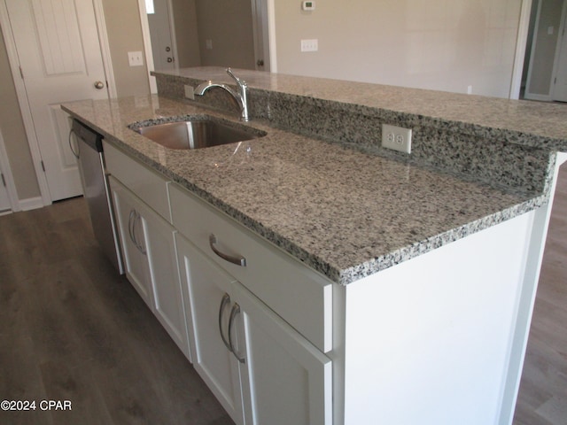 kitchen with dark hardwood / wood-style floors, sink, an island with sink, and white cabinets