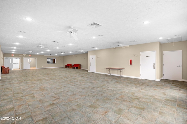 empty room featuring a textured ceiling and ceiling fan