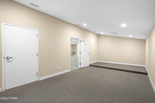 unfurnished room with carpet floors and a textured ceiling