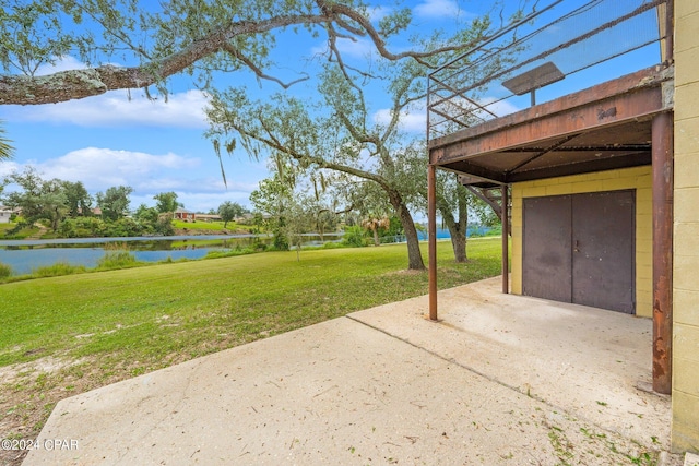 view of yard with a patio and a water view