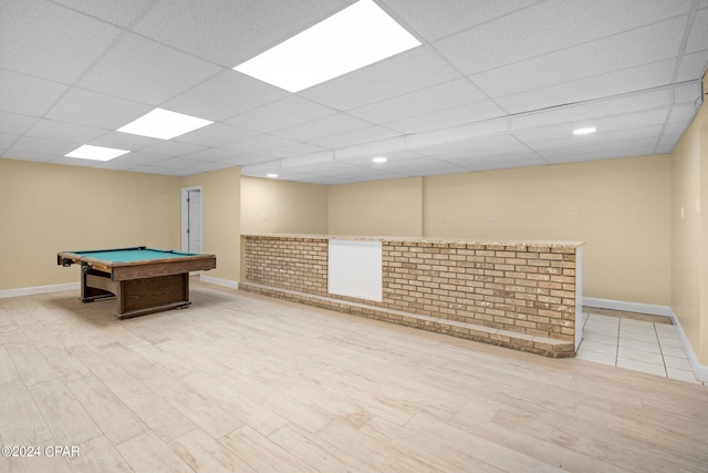 rec room featuring light hardwood / wood-style flooring, pool table, and a paneled ceiling