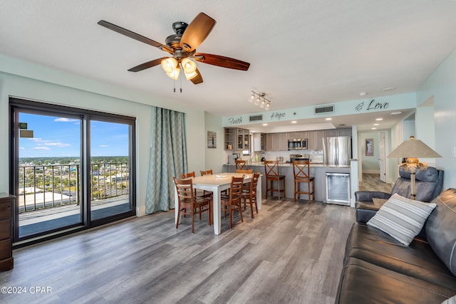 living room featuring hardwood / wood-style flooring and ceiling fan