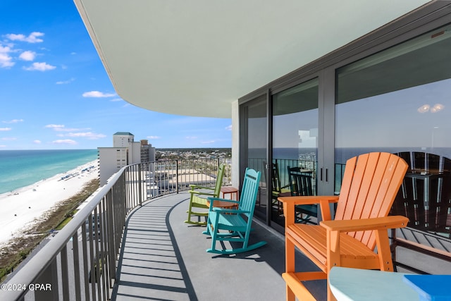 balcony featuring a water view and a beach view