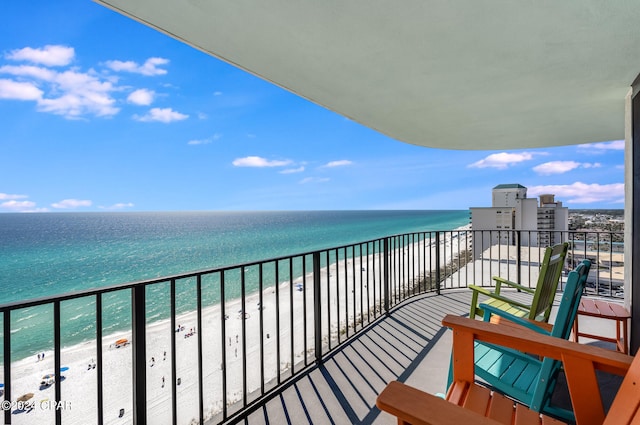 balcony featuring a beach view and a water view