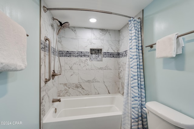 bathroom with shower / bath combination with curtain and toilet