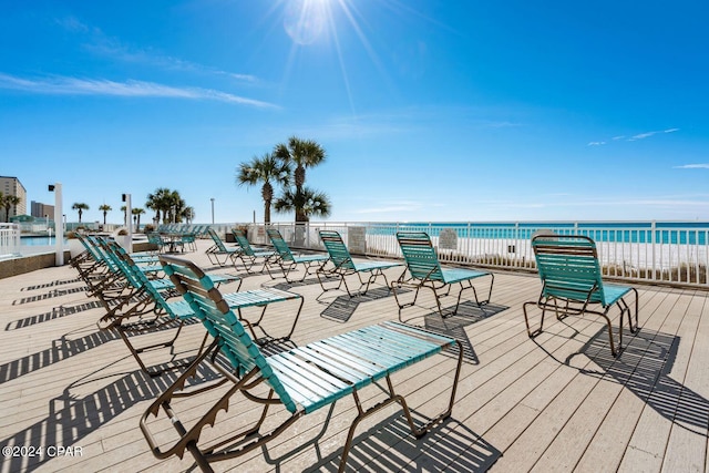 deck featuring a water view and a view of the beach