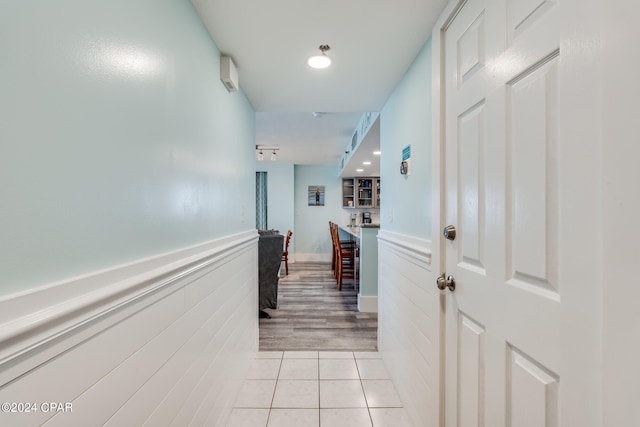 hall with light tile patterned floors