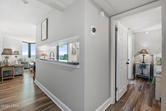 hallway with dark hardwood / wood-style flooring