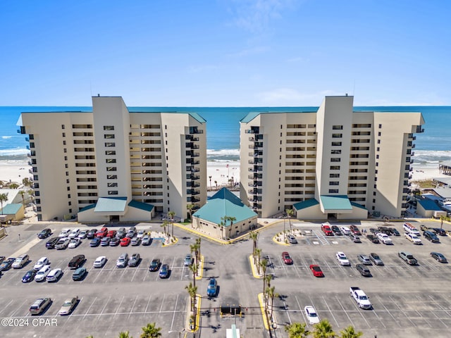 view of property with a view of the beach and a water view