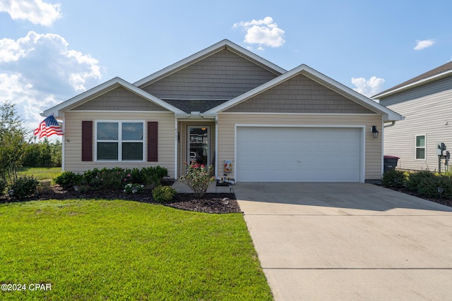 view of front facade featuring a front yard and a garage