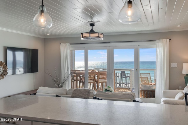 dining room with a water view, crown molding, and wooden ceiling