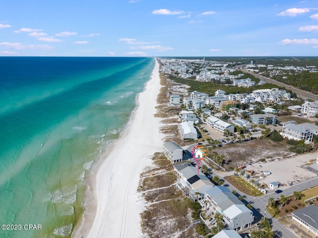 bird's eye view featuring a water view and a beach view