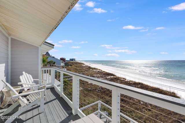 balcony featuring a water view and a view of the beach