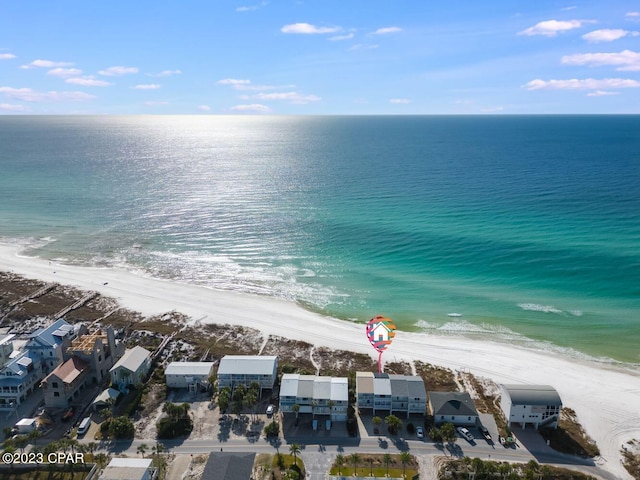 drone / aerial view featuring a beach view and a water view