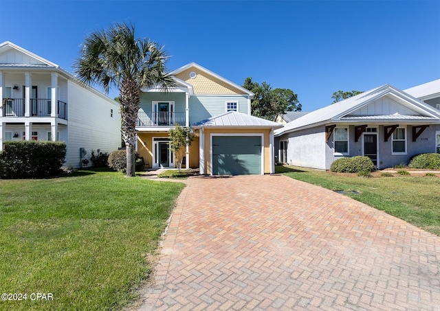 view of front of house with a balcony and a front lawn