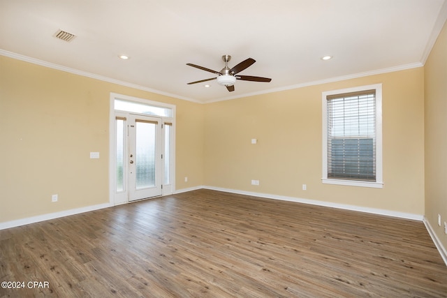 empty room featuring ceiling fan, hardwood / wood-style flooring, and ornamental molding