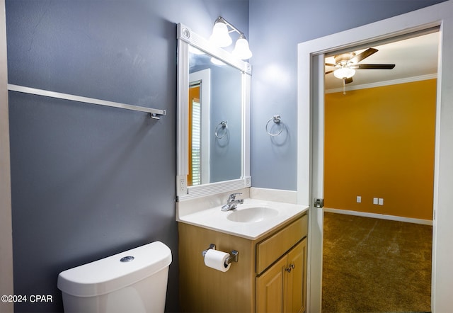 bathroom featuring ceiling fan, vanity, crown molding, and toilet