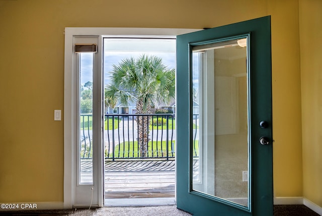 entryway with carpet floors and plenty of natural light