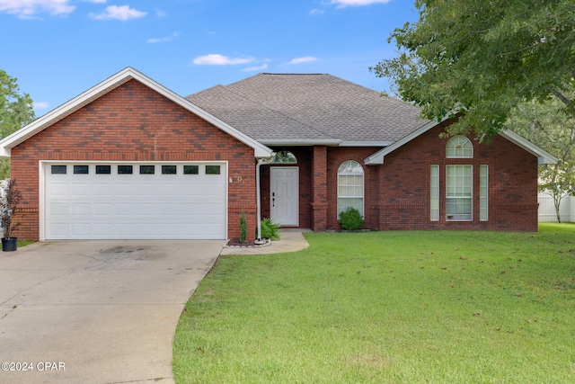 ranch-style home featuring a garage and a front lawn