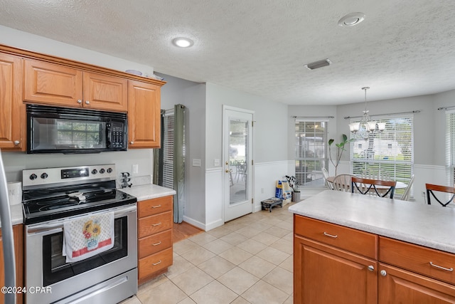 kitchen featuring pendant lighting, a textured ceiling, an inviting chandelier, light tile patterned floors, and stainless steel electric range