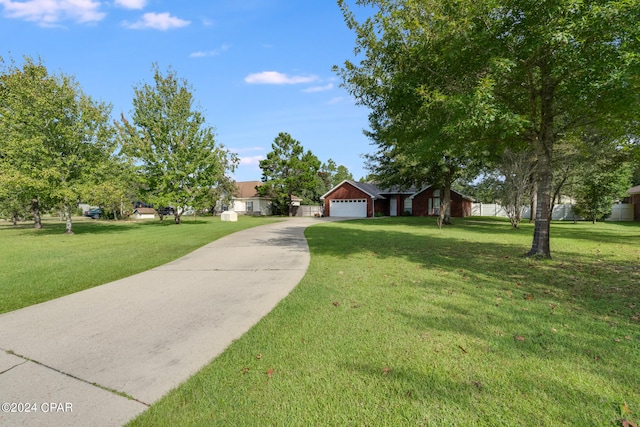 ranch-style house featuring a front yard and a garage