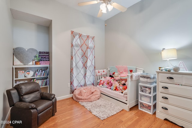 bedroom with light hardwood / wood-style floors, lofted ceiling, and ceiling fan