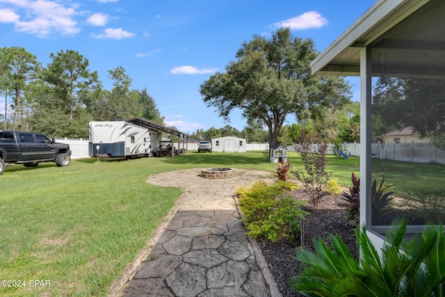 view of yard with an outdoor fire pit