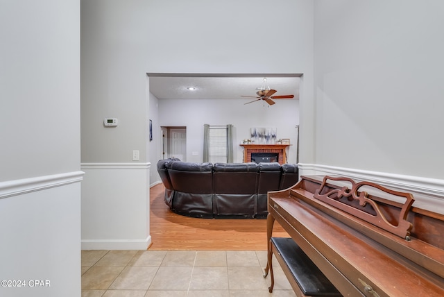 interior space featuring ceiling fan and a fireplace