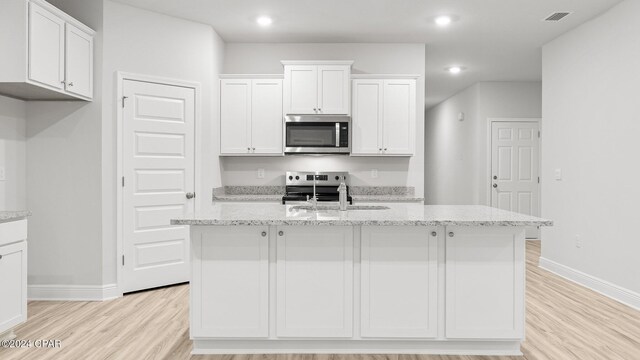 empty room with light wood-type flooring, ornamental molding, ceiling fan, and plenty of natural light