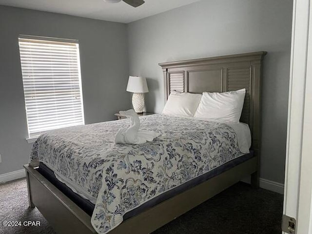 bedroom featuring ceiling fan and dark carpet