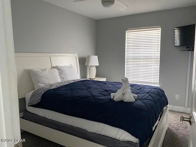 bedroom featuring dark colored carpet and ceiling fan