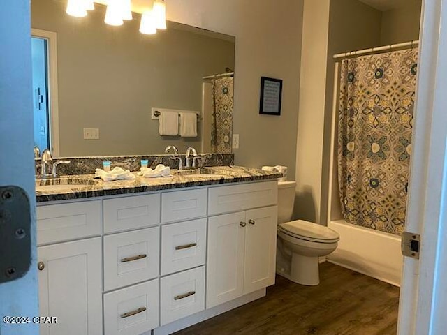 full bathroom featuring vanity, hardwood / wood-style floors, toilet, and shower / tub combo with curtain