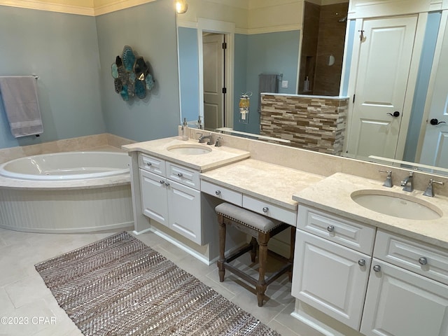 bathroom featuring vanity, tile patterned floors, and a washtub